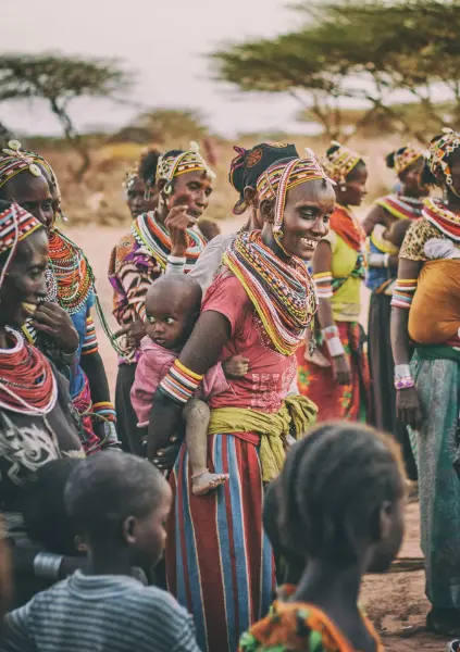A Maasai warrior in traditional attire looking over the plains.